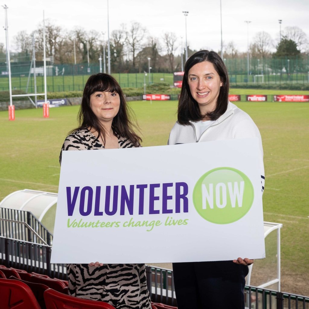 Ruth Mulholland, Volunteer Now and Rebecca Hope, Sport NI standing beside some sport playing fields