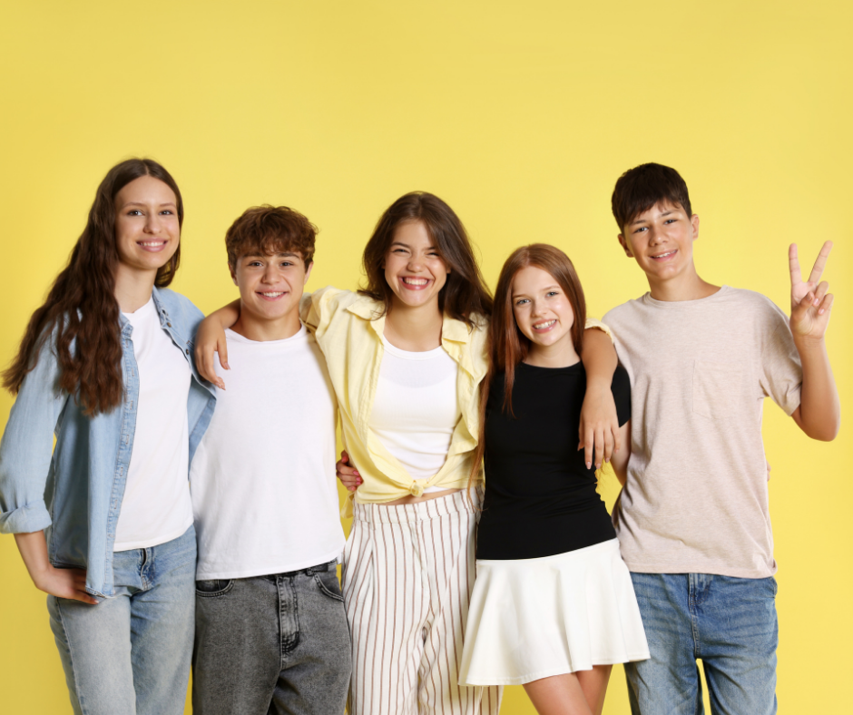 5 young people standing in a row with their arms round each others shoulders